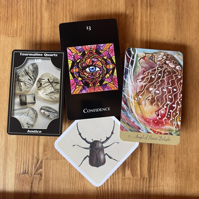 CONFIDENCE curated oracle card spread with the eye for confidence and beetle for sacred understanding